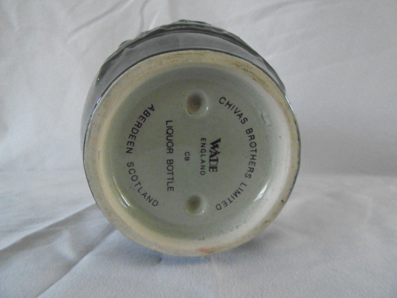 May include: A green ceramic liquor bottle with the text "Chivas Brothers Limited" and "Wade England" on the bottom. The bottle also says "Liquor Bottle CB Aberdeen Scotland".