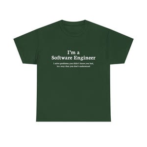 May include: Dark green t-shirt with the text "I'm a Software Engineer" in white, along with the phrase "I solve problems you didn't know you had, in a way that you don't understand."