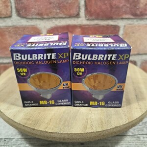 May include: Two Bulbrite XP dichroic halogen lamps, 50W 12V, in their original boxes. The boxes are orange and black with product information. The lamps are GU5.3 orange MR-16 glass covered.