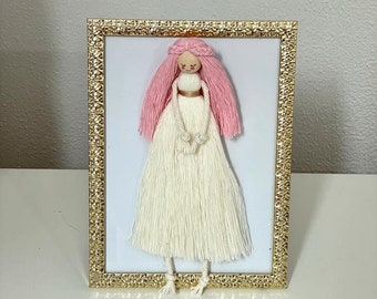 Macramé doll in frame