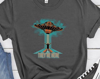 UFO t-shirt Alien invasion tee with UFO illustration Extraterrestrial sighting gift shirt Funny UFO graphic tee saying They're Here