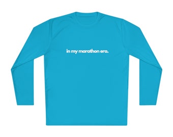 May include: A turquoise long-sleeve shirt with the text "in my marathon era." printed in white on the front.