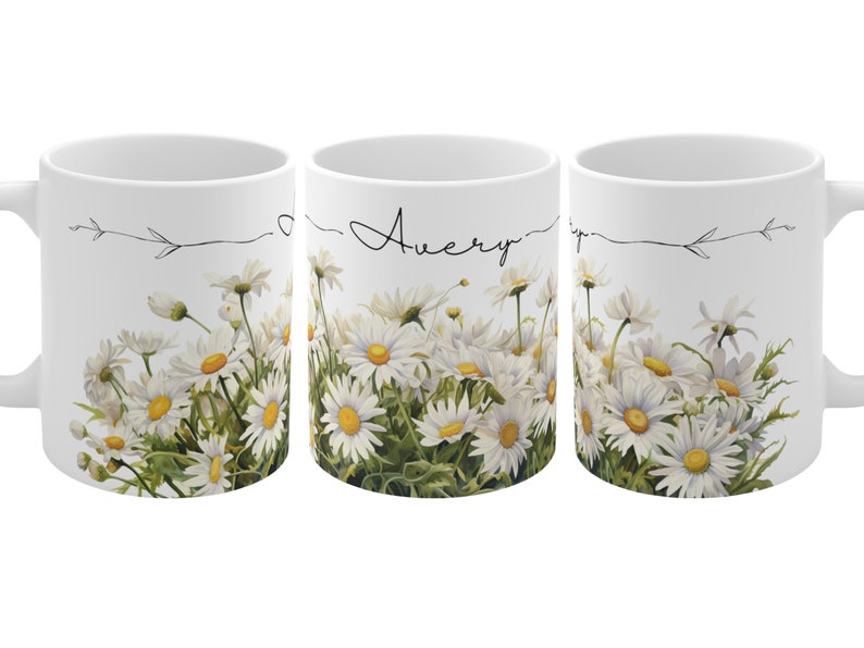 May include: White ceramic mug with a daisy floral design and the name "Avery" written in cursive on the front.