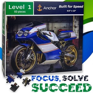 May include: A 60-piece jigsaw puzzle box featuring a blue, white, and red sport motorcycle. The box displays the text Level 1, Anchor, Built for Speed, 9.5 x 12 inches, and Focus, Solve, Succeed. Several loose puzzle pieces are shown at the bottom.