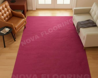May include: A large, rectangular magenta rug dominates a room with hardwood flooring. The rug is placed in front of a white sofa and a brown leather armchair. The text "NOVA FLOORING" is printed on the rug.