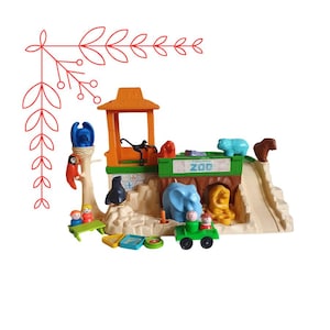 May include: A Fisher-Price Zoo playset with various colourful plastic animal figures, including a blue elephant, a yellow lion, and a brown bear. The playset includes a zoo entrance with the word "ZOO" and a green jeep.