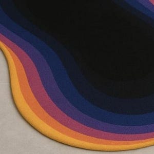 May include: A colorful, abstract rug with a wavy design. The rug features bands of color, including yellow, orange, pink, purple, and blue, transitioning to a black center. The rug's shape is organic and modern.