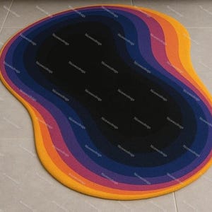 May include: A colorful, abstract area rug with a unique, organic shape. The rug features concentric layers of color, including yellow, orange, pink, purple, blue, and black. The rug is designed to add a modern touch to any room.