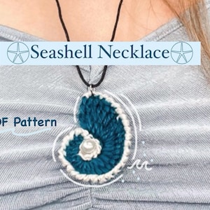 May include: A teal seashell necklace with a white pearl accent. The necklace is crocheted and has a black cord. The image includes the text "Seashell Necklace" and "PDF Pattern".