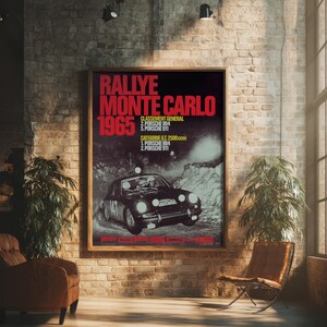 May include: A framed vintage poster with the text "RALLYE MONTE CARLO 1965" in red and white. The poster features a black Porsche race car and is displayed in a room with brick walls and a leather chair.