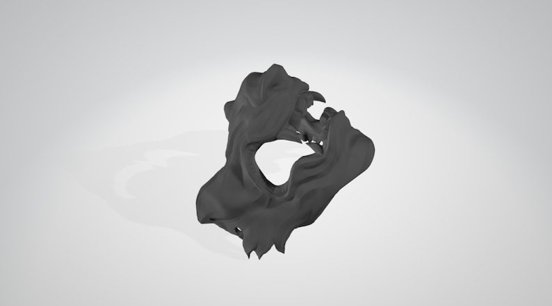 May include: A black 3D printed mask with a detailed design resembling a snarling animal face. The mask has a large open mouth and sharp teeth.