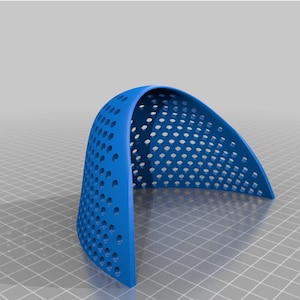 May include: A blue plastic dome-shaped object with a grid of small holes. The object is made of a flexible material and is designed to be used as a protective cover.