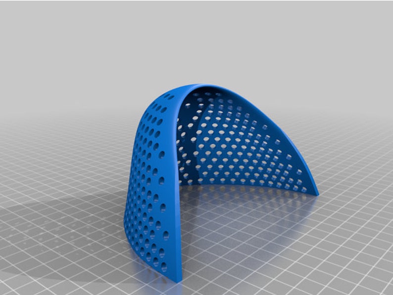 May include: A blue plastic dome-shaped object with a grid of small holes. The object is made of a flexible material and is designed to be used as a protective cover.