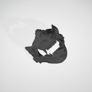 May include: A black plastic mask with a detailed design of a snarling creature's face. The mask has sharp teeth and a textured surface.