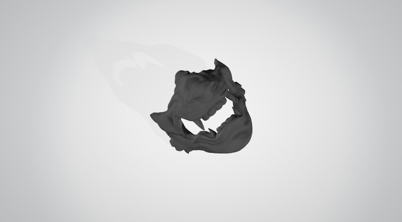 May include: A black plastic mask with a detailed design of a snarling creature's face. The mask has sharp teeth and a textured surface.