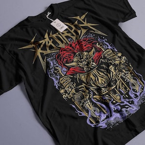 May include: Black t-shirt with a gold and purple graphic print of a horned, red-haired creature holding a sword. The text "RADIATE" is printed in gold above the creature.