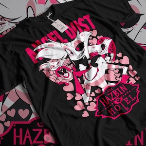 May include: Black t-shirt with a pink and white graphic of a cartoon character with the text "Angel Dust" and "Hazbin Hotel".