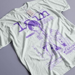 May include: White t-shirt with a purple graphic design. The design features an anime-style illustration of a girl and text that reads "serial experiments lain", "FATAL ERROR", and "we are all connected". The shirt has a "LARGE" tag.