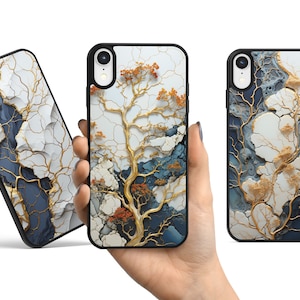 May include: Three black phone cases with a white, gold, and blue abstract design. The design features a tree-like pattern with branches and leaves.