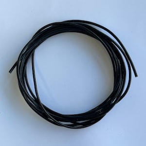 May include: A coil of black leather cord, ideal for crafting jewellery or other projects.