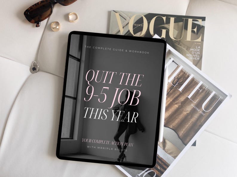 May include: A black and white digital tablet with a pink and white text overlay that reads "Quit the 9-5 Job This Year: Your Complete Action Plan with MER/PLR Rights". The tablet is on a white surface with a magazine on top of it.