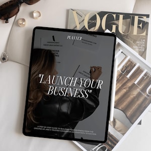 K&ouml;nnte beinhalten: Ein Tablet-Bildschirm zeigt einen Business-Planer mit dem Text "Starten Sie Ihr Unternehmen" und eine Schritt-f&uuml;r-Schritt-Anleitung zum Aufbau eines Unternehmens von Grund auf.