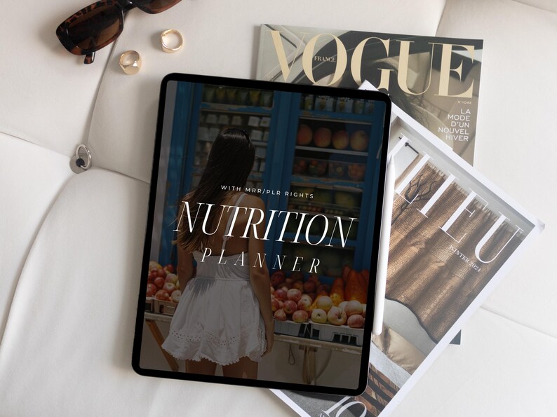May include: A digital tablet displaying a nutrition planner with the text "WITH MRR/PLR RIGHTS NUTRITION PLANNER" on a white background. The tablet is surrounded by magazines.