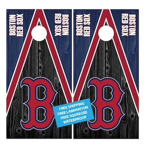 May include: Two wooden cornhole boards with a black wood grain background. The boards are painted with a red and blue triangle pattern. The Boston Red Sox logo is featured on each board. The text "Boston Red Sox" is printed on each board. The text "Free Shipping, Free Lamination, Free Squeegee, Waterproof" is printed on a blue sticker on the right board.