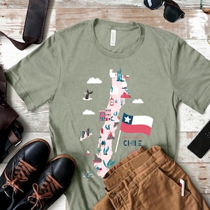 May include: A green t-shirt with a graphic of a stylized map of Chile, featuring various landmarks and the Chilean flag. The text "Time to Explore Chile" is printed below the map.