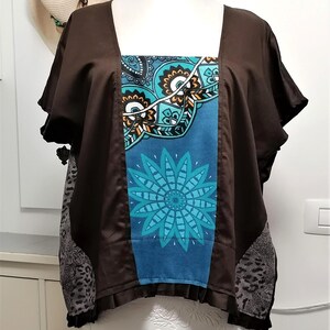 May include: A brown square-neck top with short sleeves. The front panel features a blue and teal floral design. The sides have a grey and black animal print. The top is displayed on a mannequin.