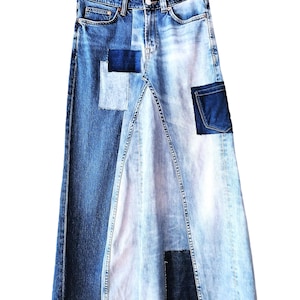 May include: A denim skirt with a patchwork design. The skirt features a combination of light and dark blue denim panels, with darker blue patches. The skirt is hanging on a hanger against a white background.