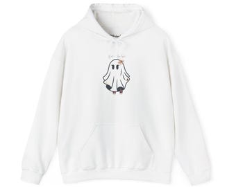 May include: White hooded sweatshirt with a front pocket and drawstring. The sweatshirt features a cartoon ghost graphic with the text "Wild & Spooky" above the ghost. The ghost is wearing black pants and red shoes.