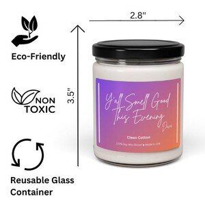 May include: A glass candle jar with a black lid and a purple, pink, and orange ombre label. The label reads "Y'all Smell Good This Evening" with a handwritten font. The candle is 3.5 inches tall and 2.8 inches wide. The candle is made with 100% soy wax blend and is made in the USA. The candle is labeled as "Clean Cotton".
