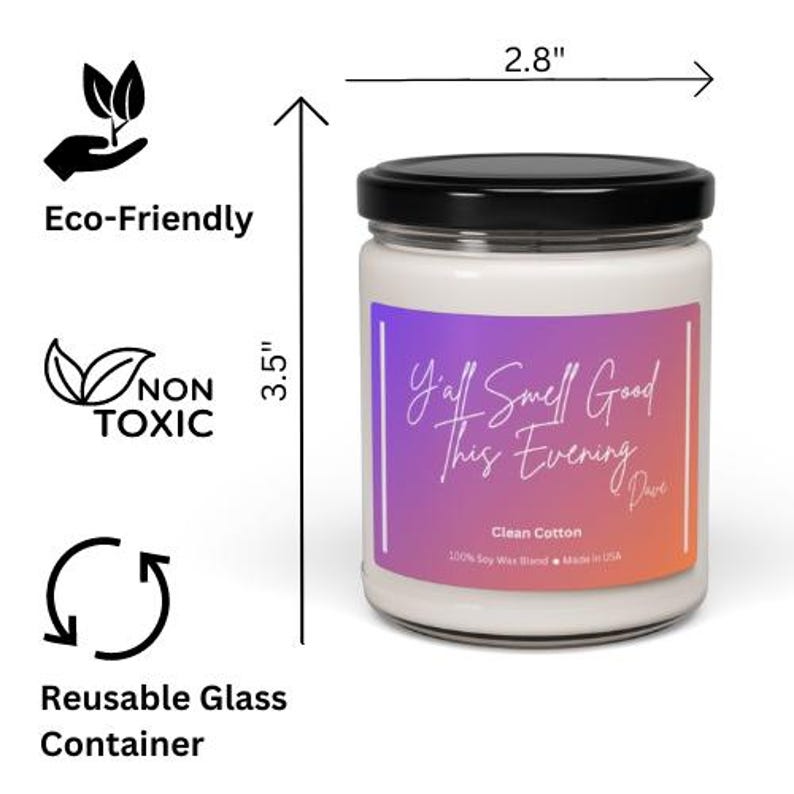 May include: A glass candle jar with a black lid and a purple, pink, and orange ombre label. The label reads "Y'all Smell Good This Evening" with a handwritten font. The candle is 3.5 inches tall and 2.8 inches wide. The candle is made with 100% soy wax blend and is made in the USA. The candle is labeled as "Clean Cotton".