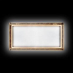 an empty picture frame on a black background