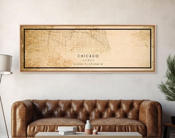 May include: A vintage-style map print of Chicago, Illinois, with a beige background and black lines depicting the city's streets. The map is framed in a light wood frame and includes the city's name, state, and coordinates: "CHICAGO, ILLINOIS, 41.8781° N | 87.6298° W".