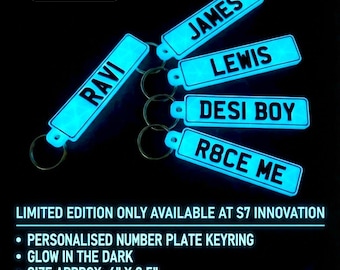 May include: Five rectangular glow-in-the-dark keychains with black text reading RAVI, JAMES, LEWIS, DESI BOY, and R8CE ME. Each keychain features a metal ring and measures approximately 4 inches by 0.5 inches. The text NIGHT VIEW is visible.