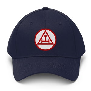 May include: A navy blue baseball cap with a red and white embroidered patch featuring a triangle with a letter 'I' and a horizontal line.