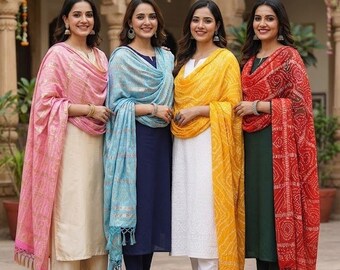 May include: Four outfits consisting of long tunics and trousers paired with draped dupattas in pink, light blue, yellow, and red. The garments feature solid colors, metallic patterns, and textured fabrics with tassels. The text Reference Photo Only is visible.