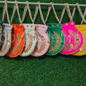 May include: Assortment of nine small, round, drawstring bags with embroidered peacock designs. The bags are in various colors, including blue, silver, orange, white, pink, green, pink, yellow, and gold.