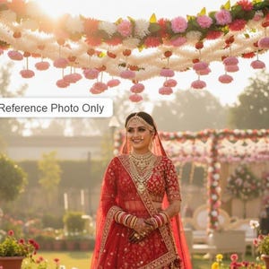 May include: A woman in a red wedding dress stands under a floral archway. The dress features intricate embroidery and jewelry. The arch is decorated with pink, white, and red flowers, creating a festive atmosphere. The text "Reference Photo Only" is visible.