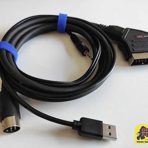May include: A black cable with a blue strap, a black USB connector, a black and silver connector with a label that says "CPC 464", and a black connector with a silver tip.