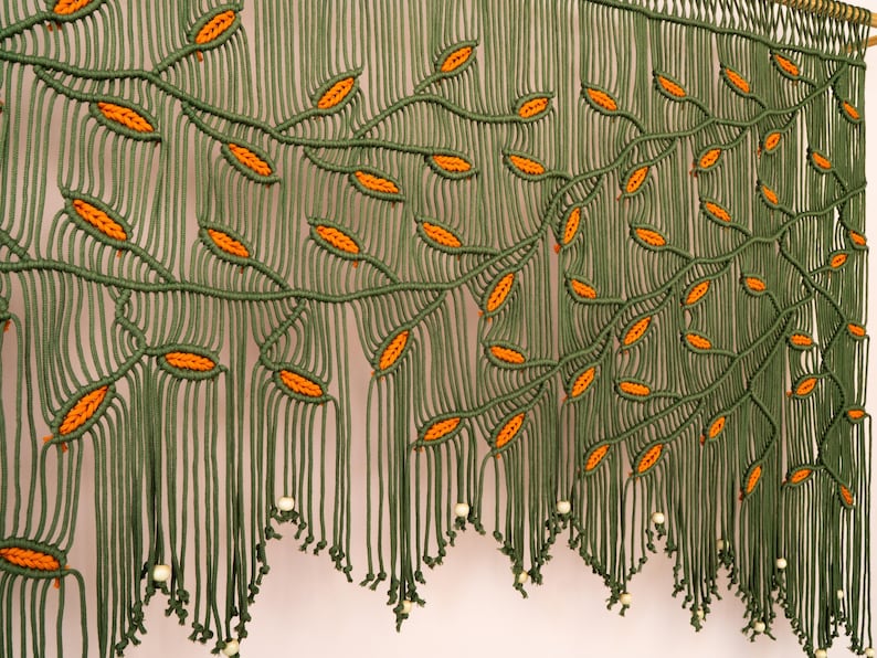Unique housewarming gift: a handcrafted olive green and burnt orange macrame piece.