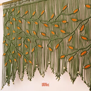 Sophisticated macrame doorway curtain in a rich botanical olive and orange colorway.
