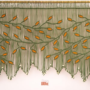 Custom-made macrame valance featuring trailing orange vines and decorative beaded finishes.