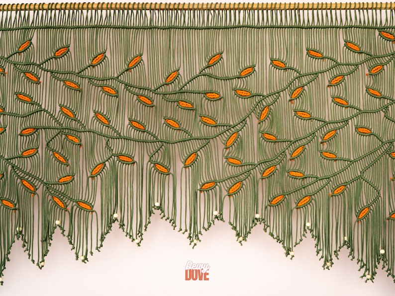 Custom-made macrame valance featuring trailing orange vines and decorative beaded finishes.