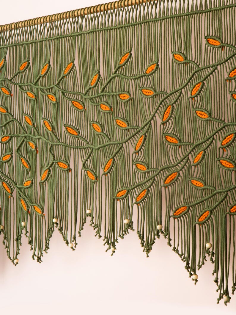 Handcrafted olive macrame tapestry with a multi-layered architectural scalloped fringe.