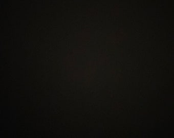 May include: A solid black background with a subtle texture.