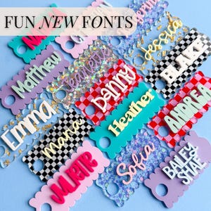 a collection of colorful name tags or tags with various names written on them, arranged in a visually appealing manner.
