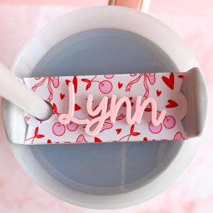 a cup of water with a spoon inside of it